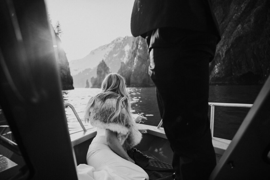 bride looking out on alaska lake during elopement