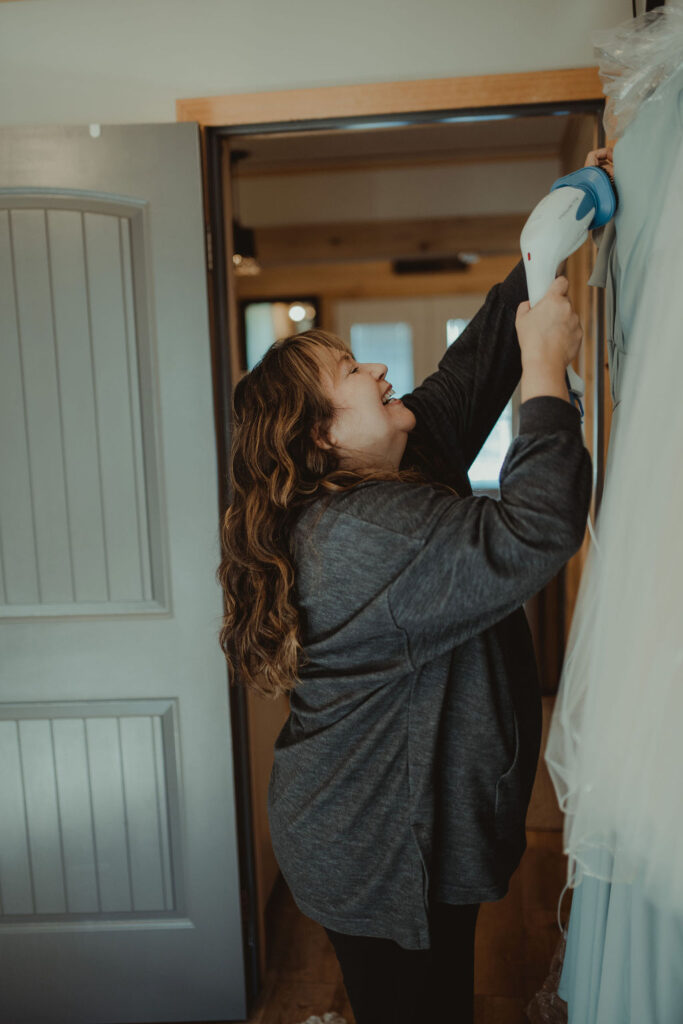 mother of the bride steaming a dress