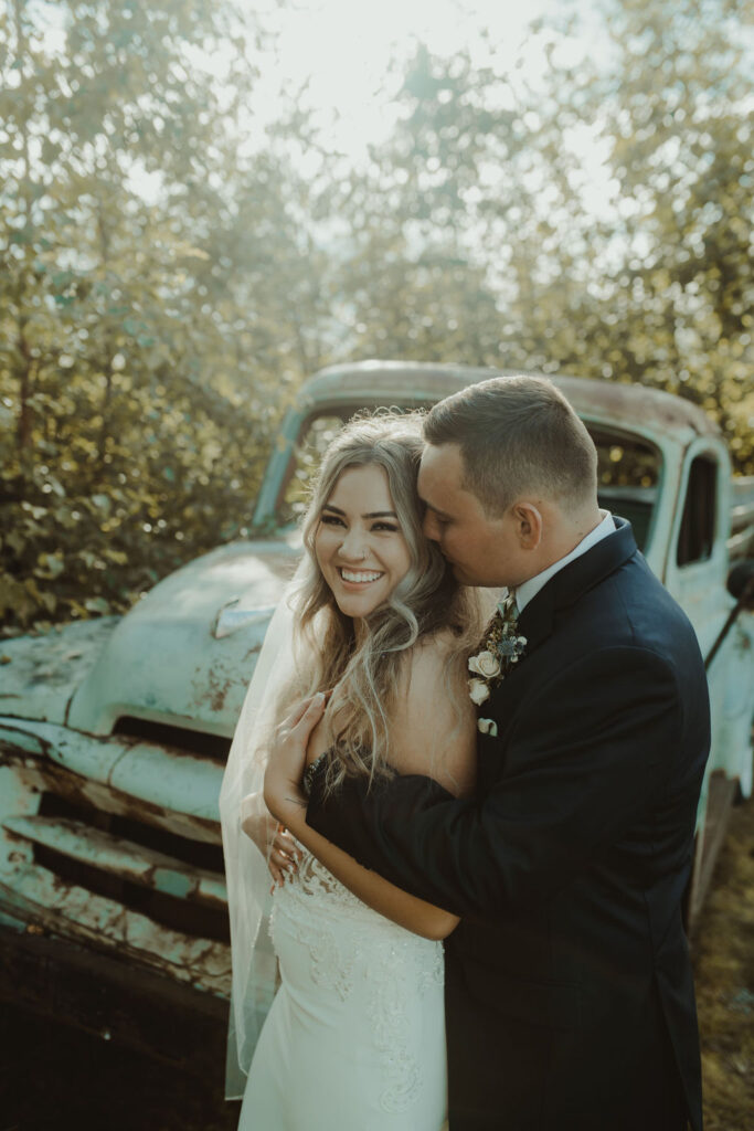 groom kissing the bride on the cheek