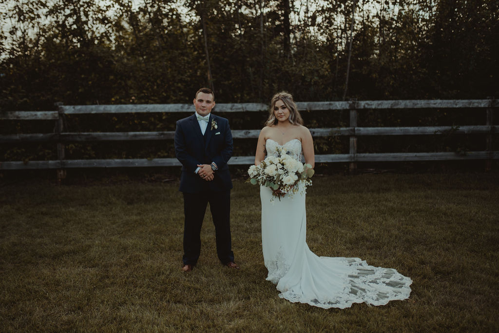 bride and groom standing next to each other