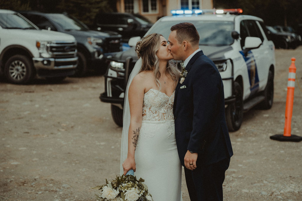 newly married couple kissing at their wedding