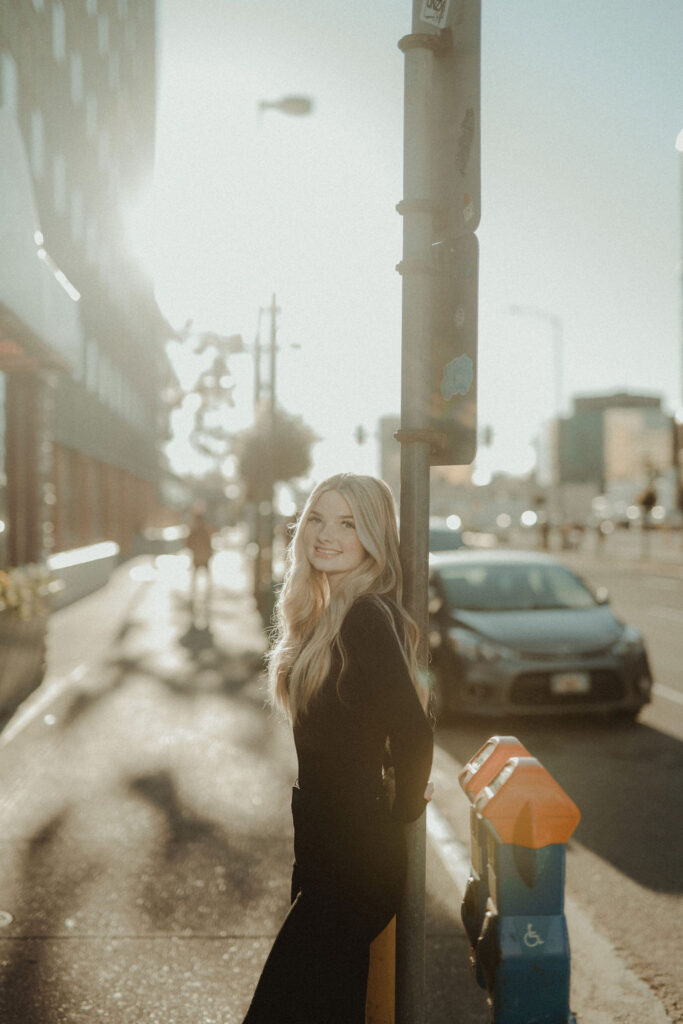 girl posing to the camera with the sun in the background