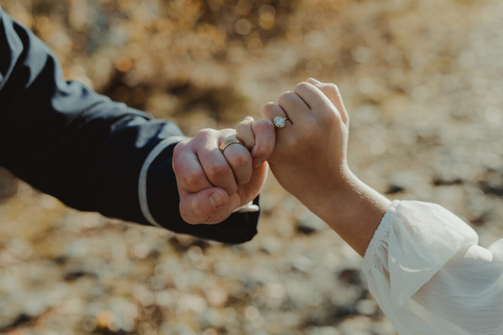 bride and groom showing their engagement rings
