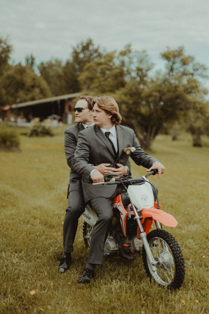 The groom gives a pal a ride on a dirtbike