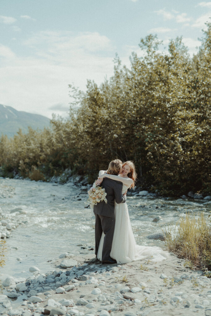 Bride and groom share a hug at granite creek