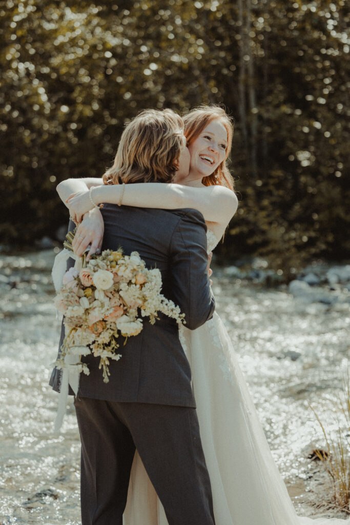 bride and groom hug at granite creek