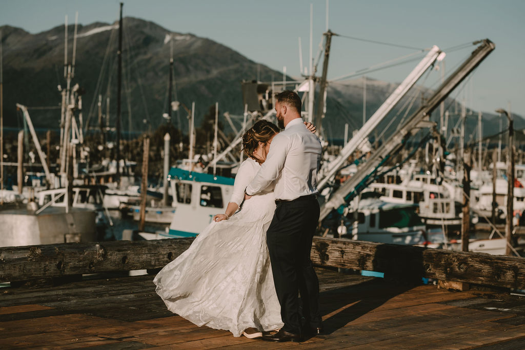 couple dancing on dock during wedding photos 