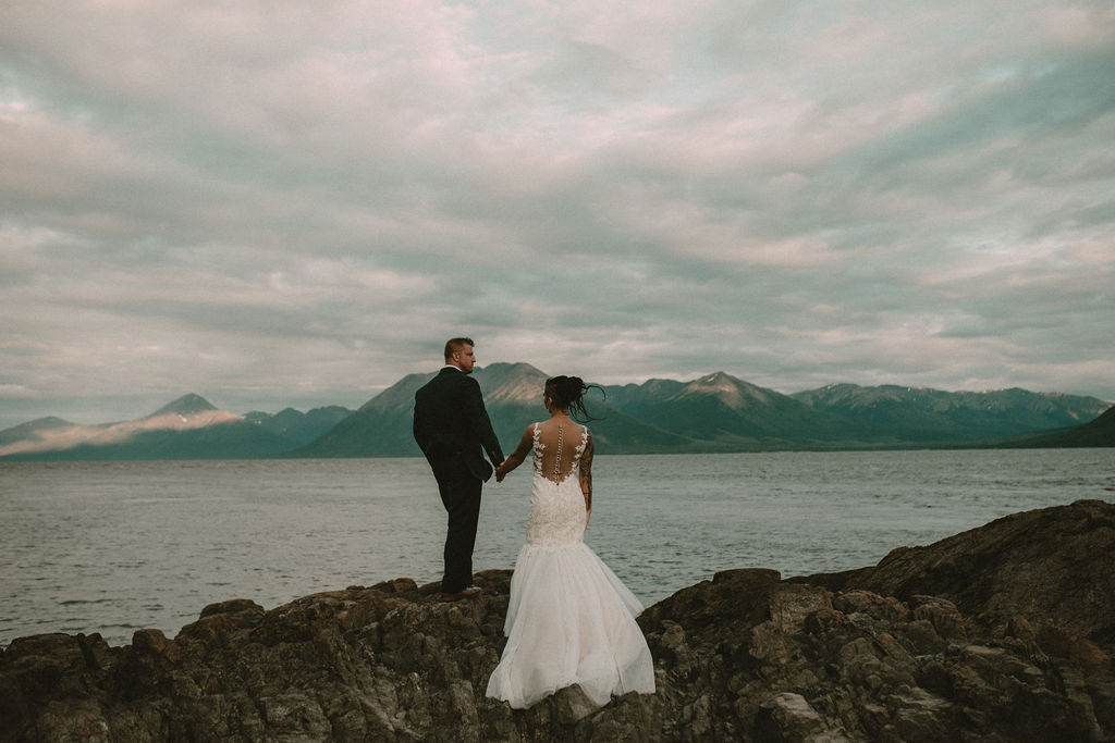 Couple holding hands during an alaska elopement