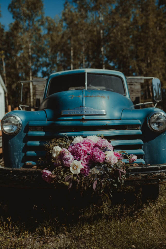 vintage truck with flowers at the rustic modern wedding