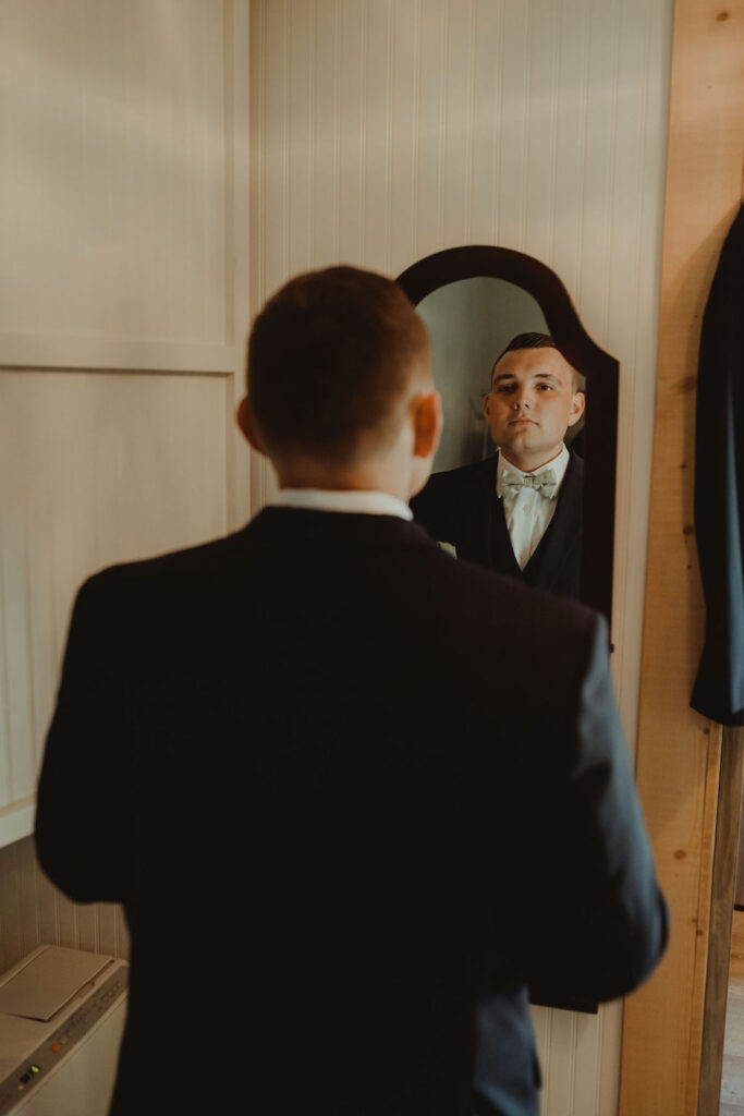 groom getting ready for his rustic modern wedding ceremony