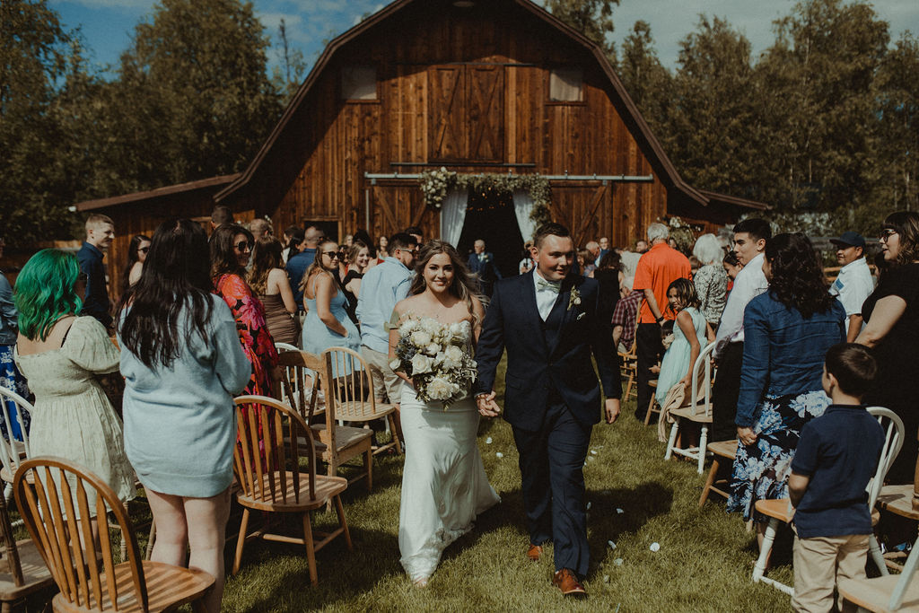 couple leaving the rustic modern wedding ceremony 
