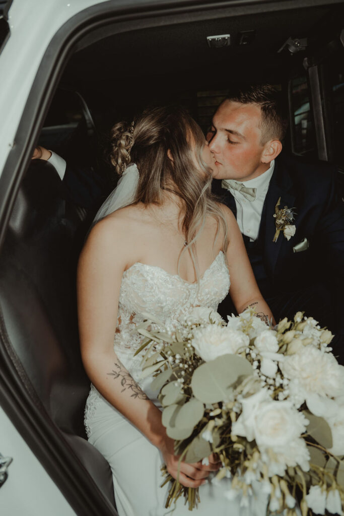 couple kissing at their rustic modern wedding 