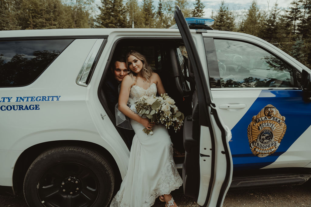 newly married couple inside a police truck 
