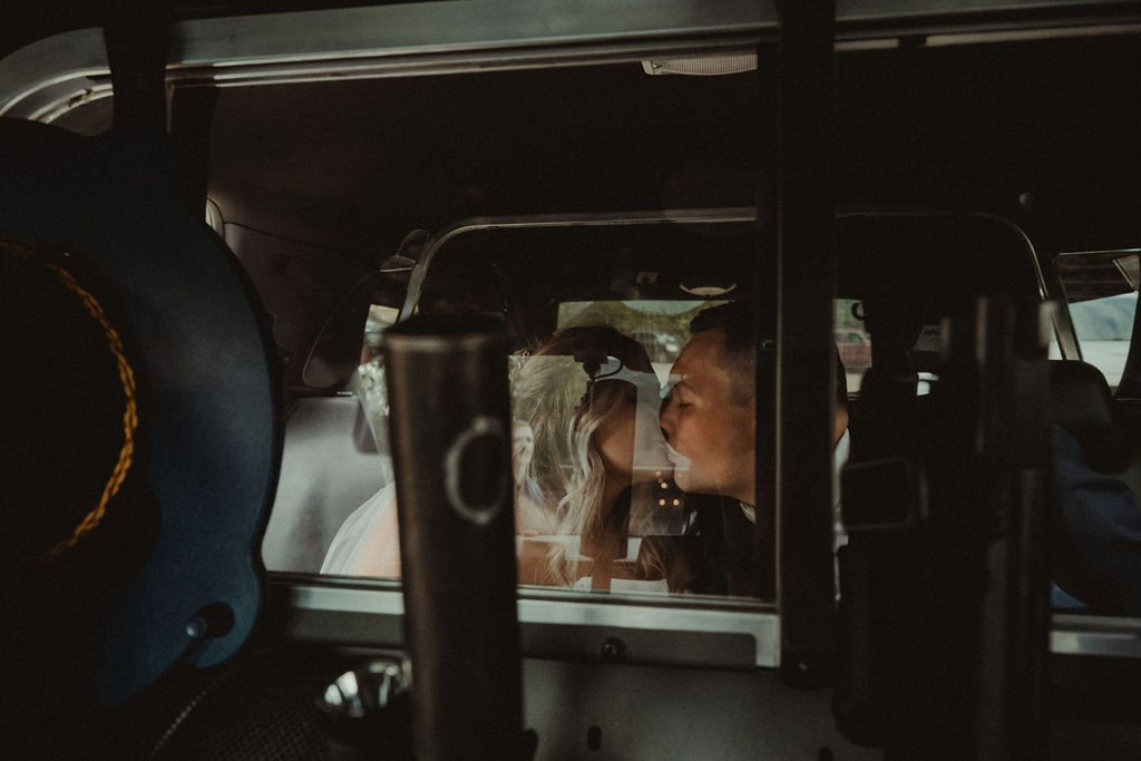 couple kissing inside the police car