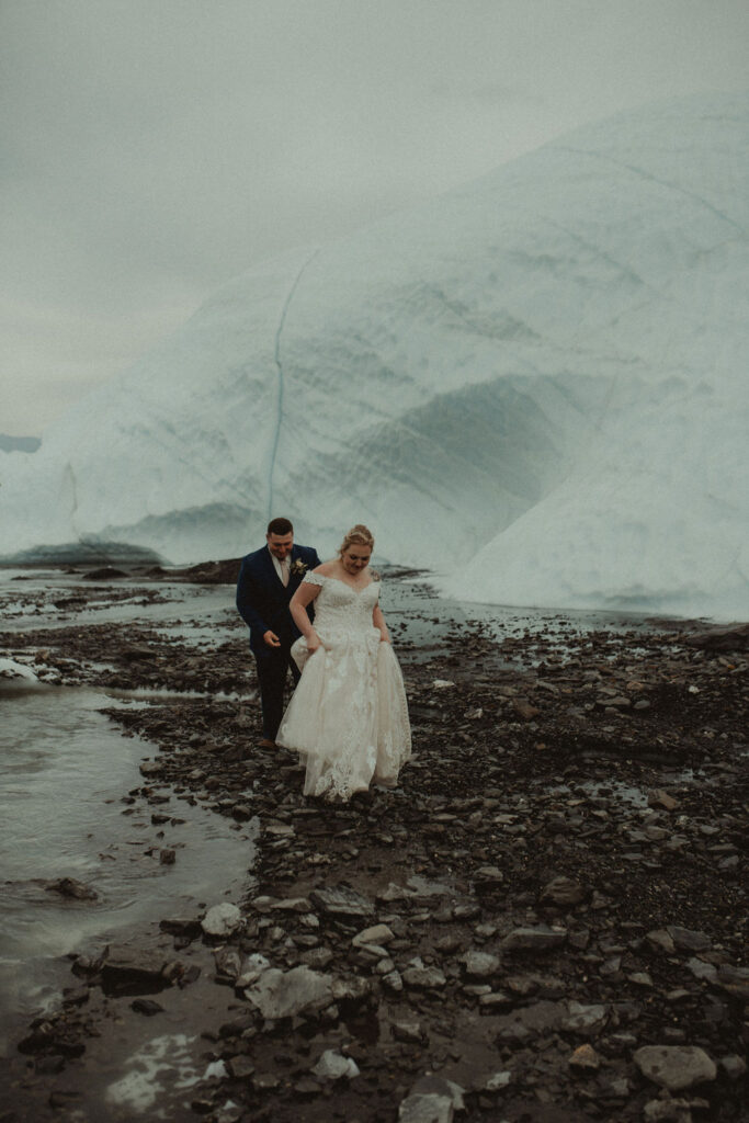 couple walking at matanuska glacier at their epic alaskan elopement 