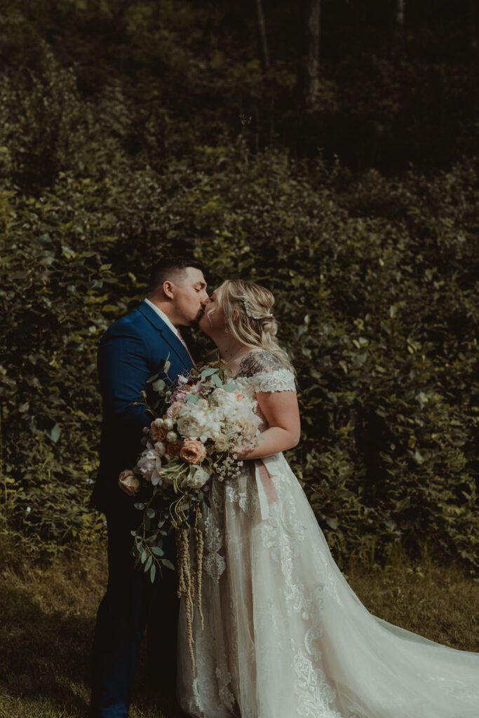bride and groom kissing at their epic alaskan elopement 