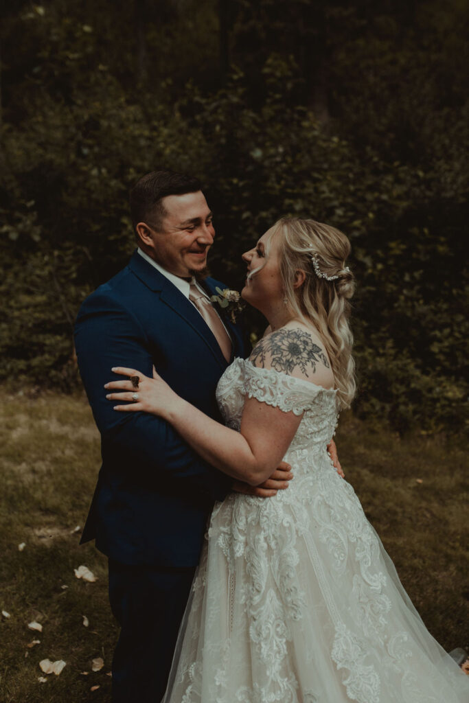 couple smiling at each other before their epic alaskan elopement ceremony 