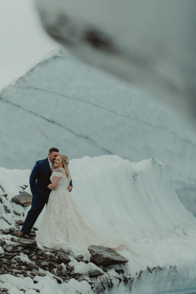 groom kissing the bride on the cheek at matanuska glacier 