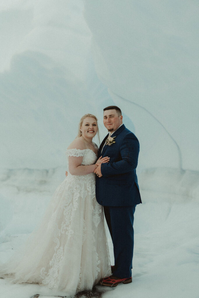 bride and groom looking at the camera at their epic alaskan elopement session 