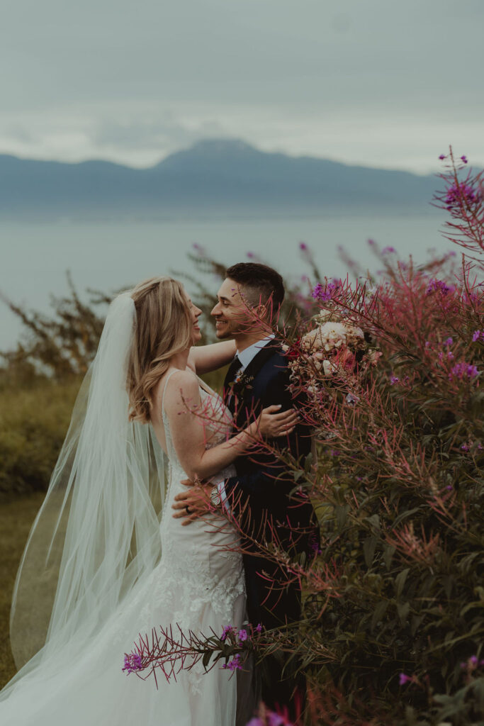 couple looking at each other at their alaska elopement