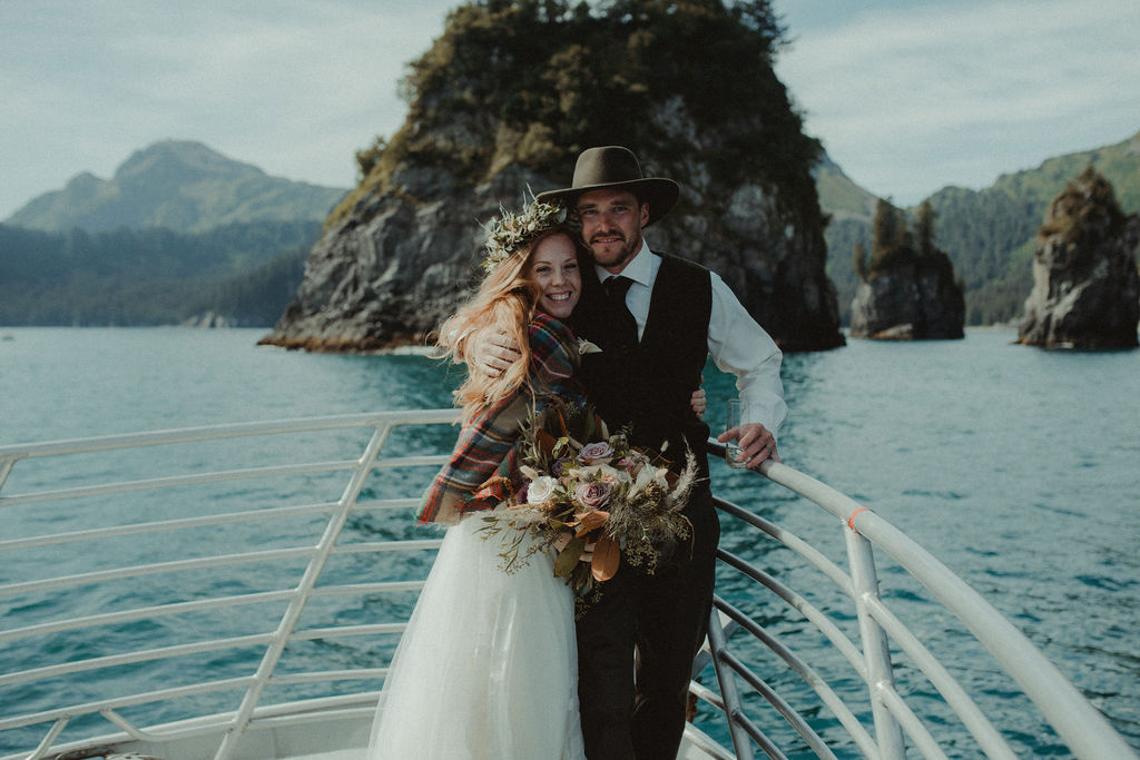 bride and groom looking at the camera during their intimate boat elopement