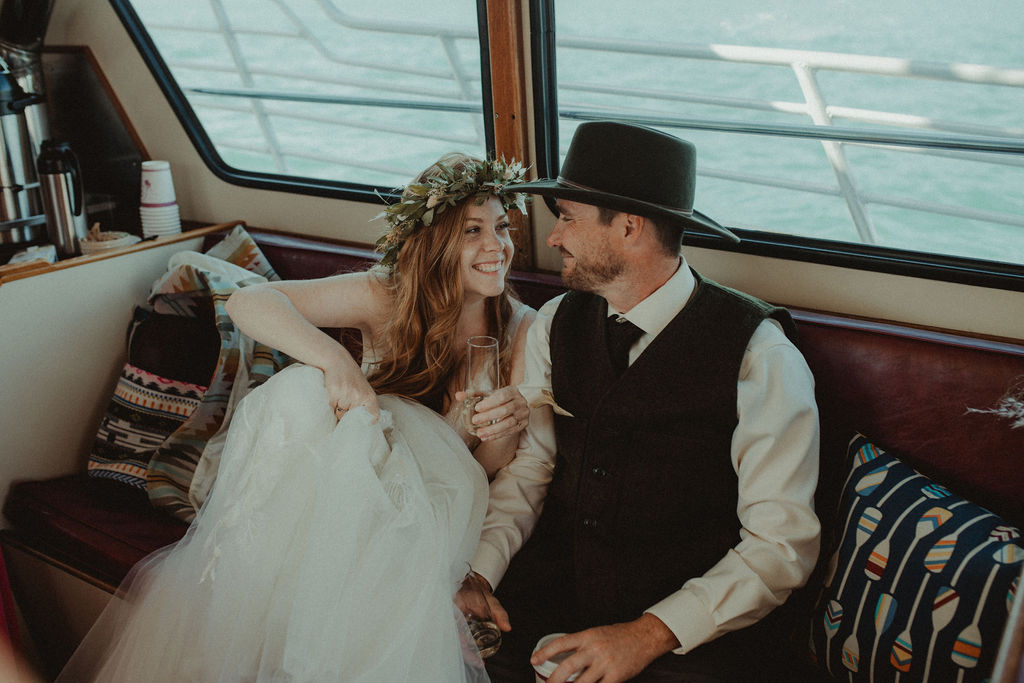 bride and groom smiling at each other at their intimate boat elopement