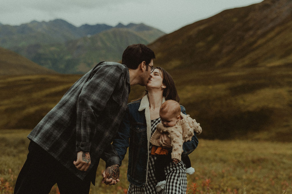 couple kissing during their mountain family session