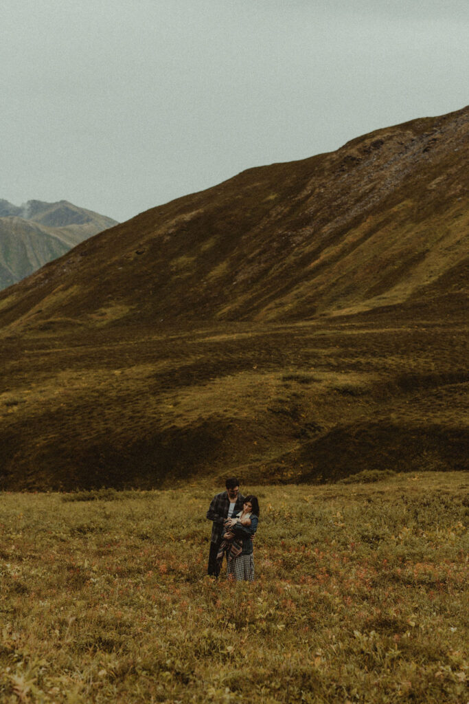 couple and their baby walking around hatcher pass