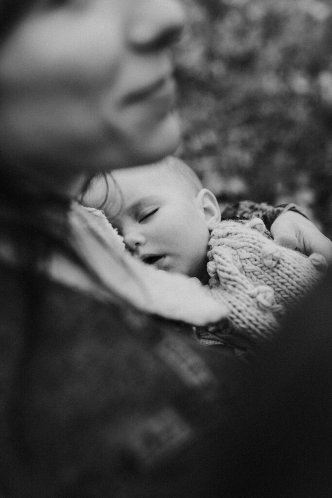 little baby girl sleeping during her family photoshoot