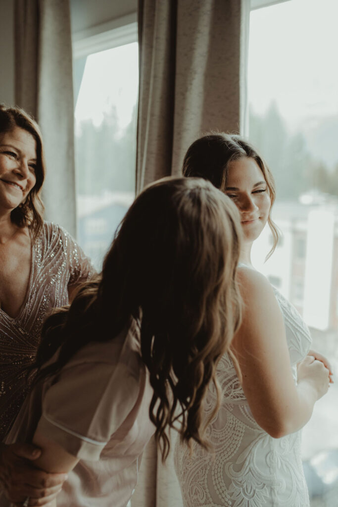 bride putting on her wedding dress for her ceremony