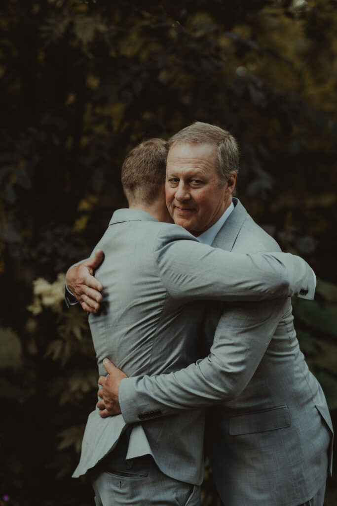 groom hugging his dad