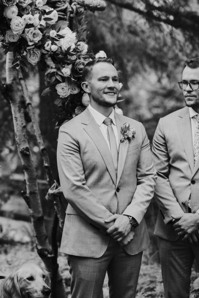 groom watching the bride walk down the aisle