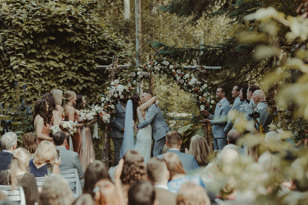 bride and groom kissing after their wedding ceremony