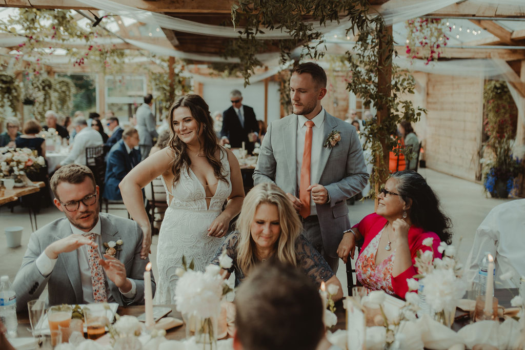 bride and groom talking with their wedding guests