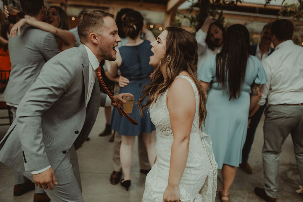 bride and groom dancing with their wedding guests at the wedding reception