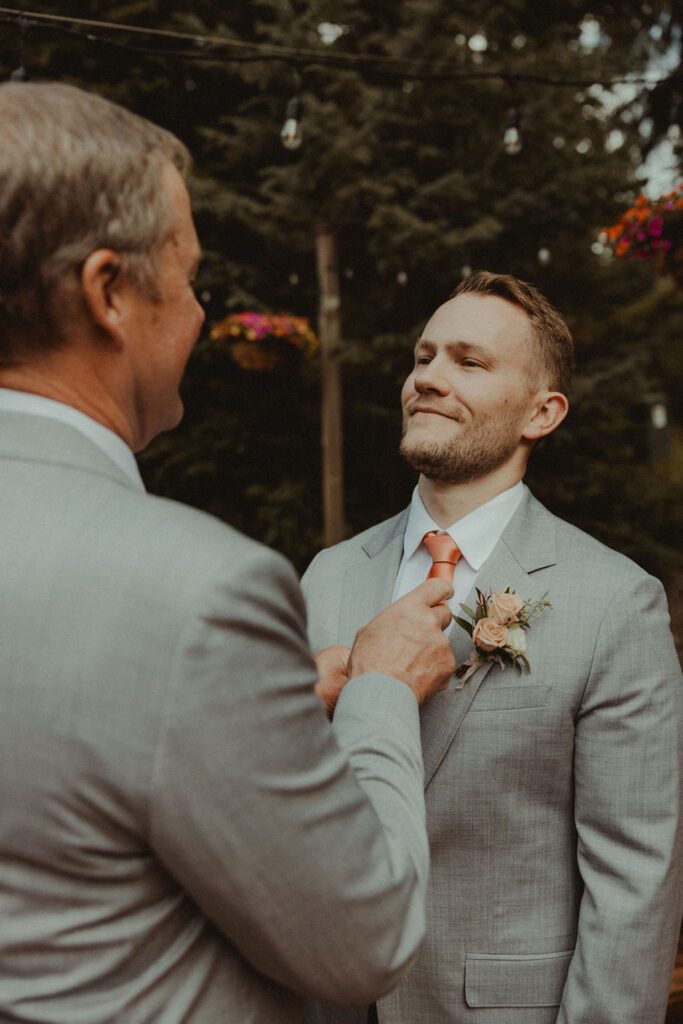 groom getting ready for his fun summer wedding