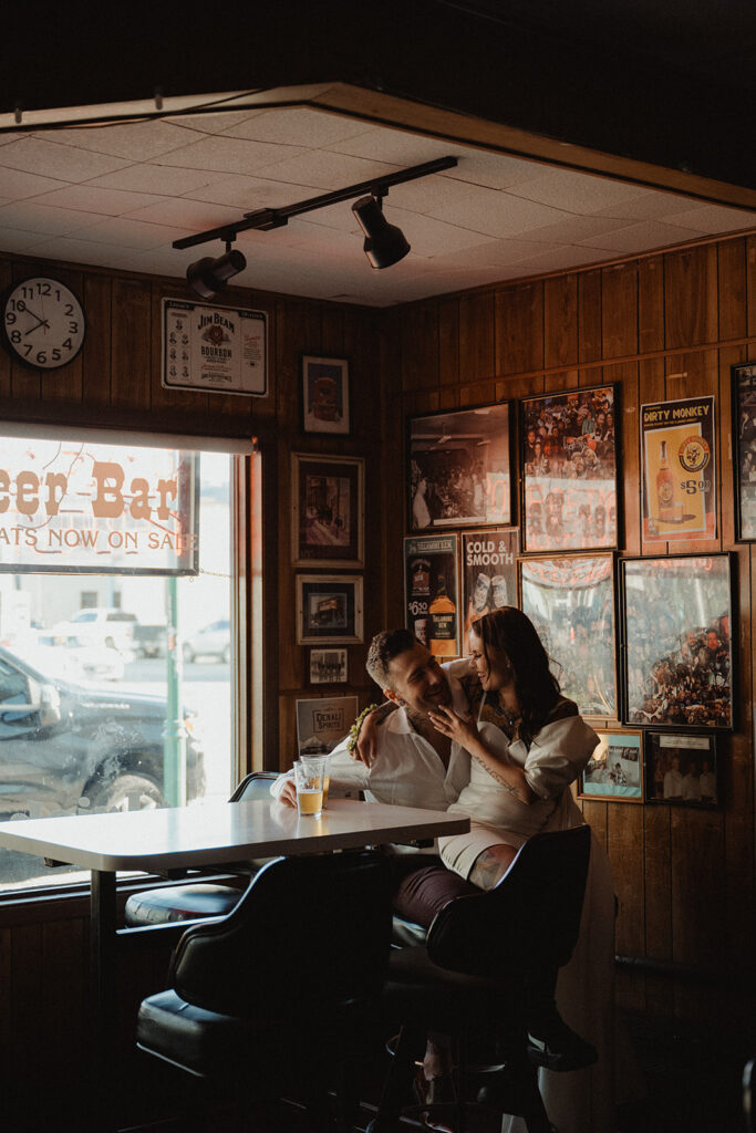 bride and groom talking at a bar