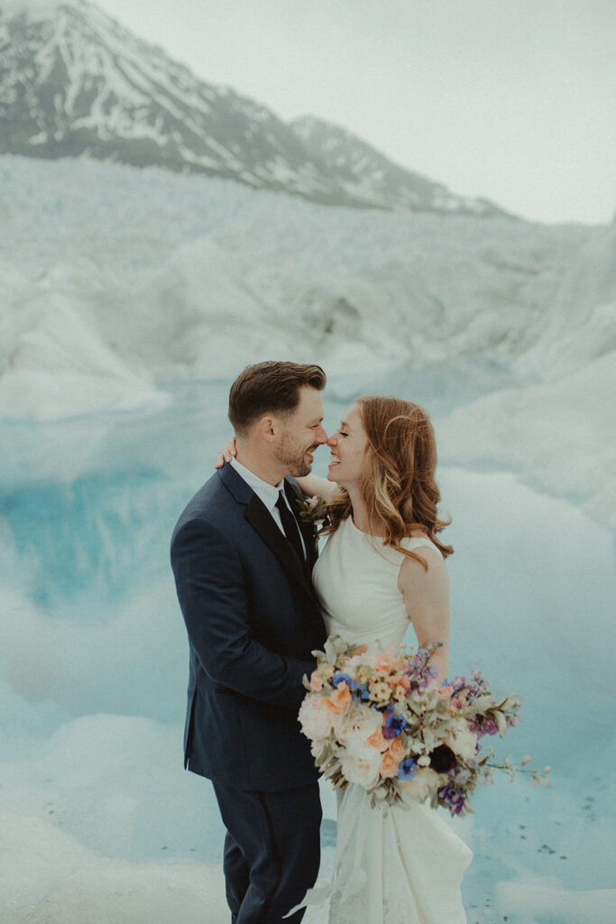 bride and groom kissing - Helicopter for Your Alaska Elopement