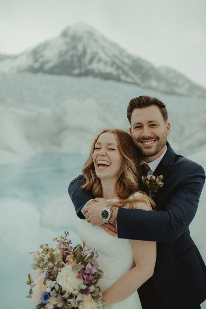 bride and groom laughing with each other  