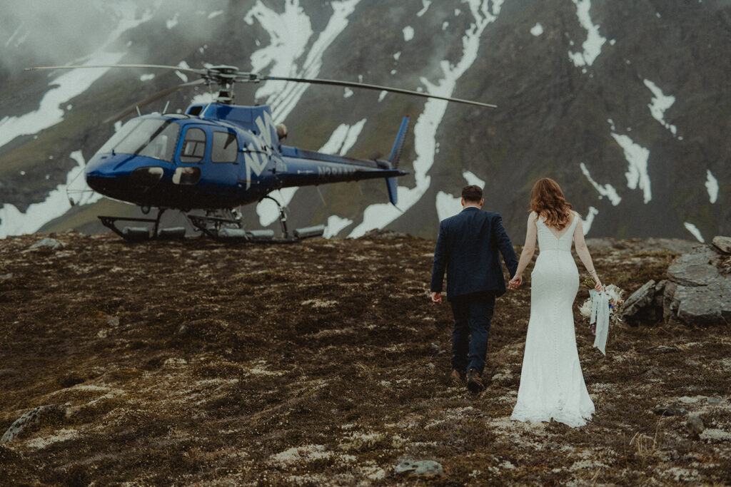 bride and groom heading to their helicopter ride