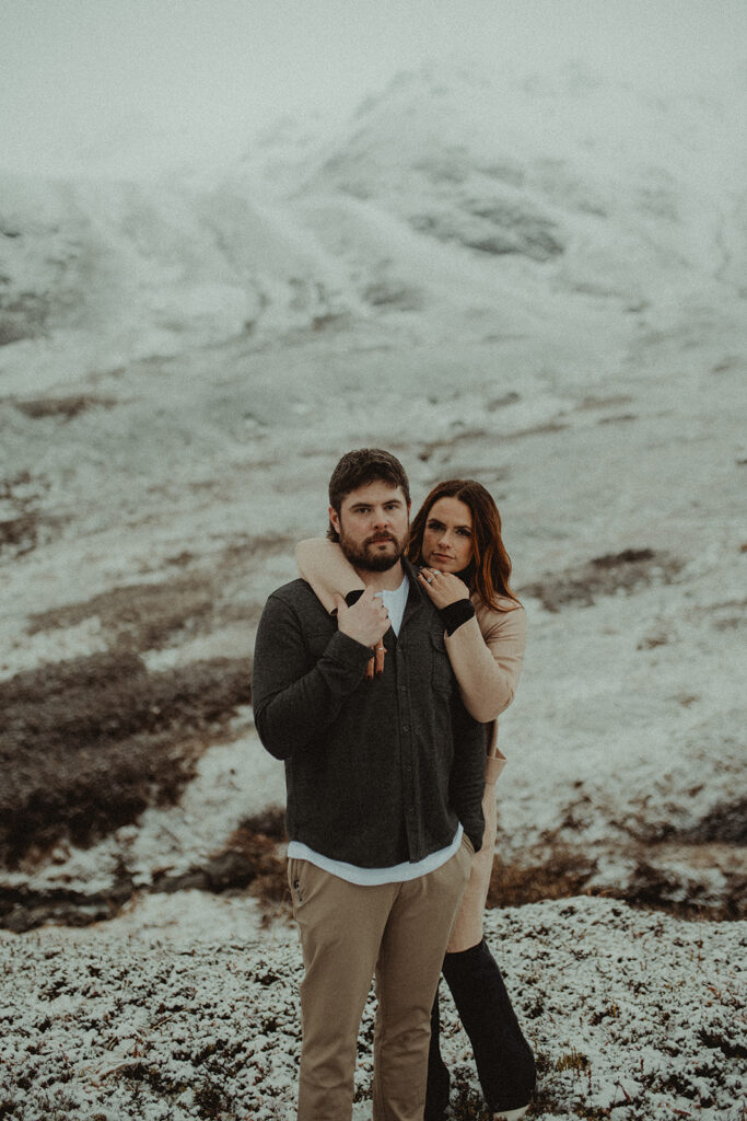 couple looking at the camera during their winter couples shoot