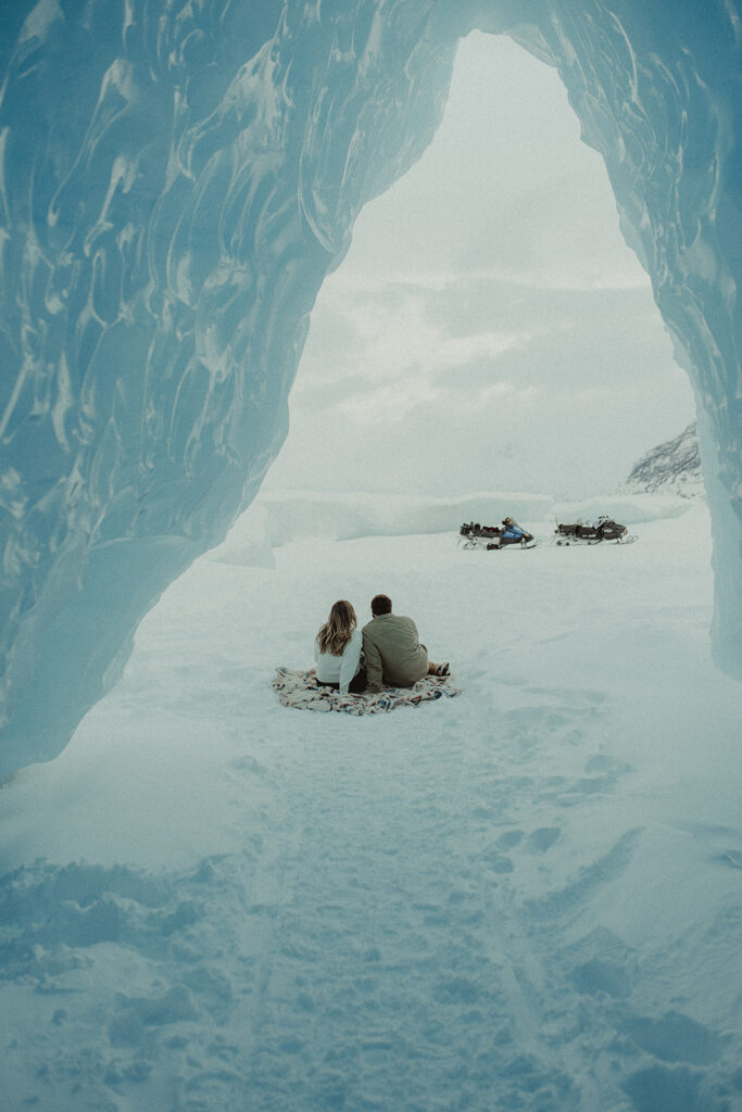 couple sitting watching the knik glacier 