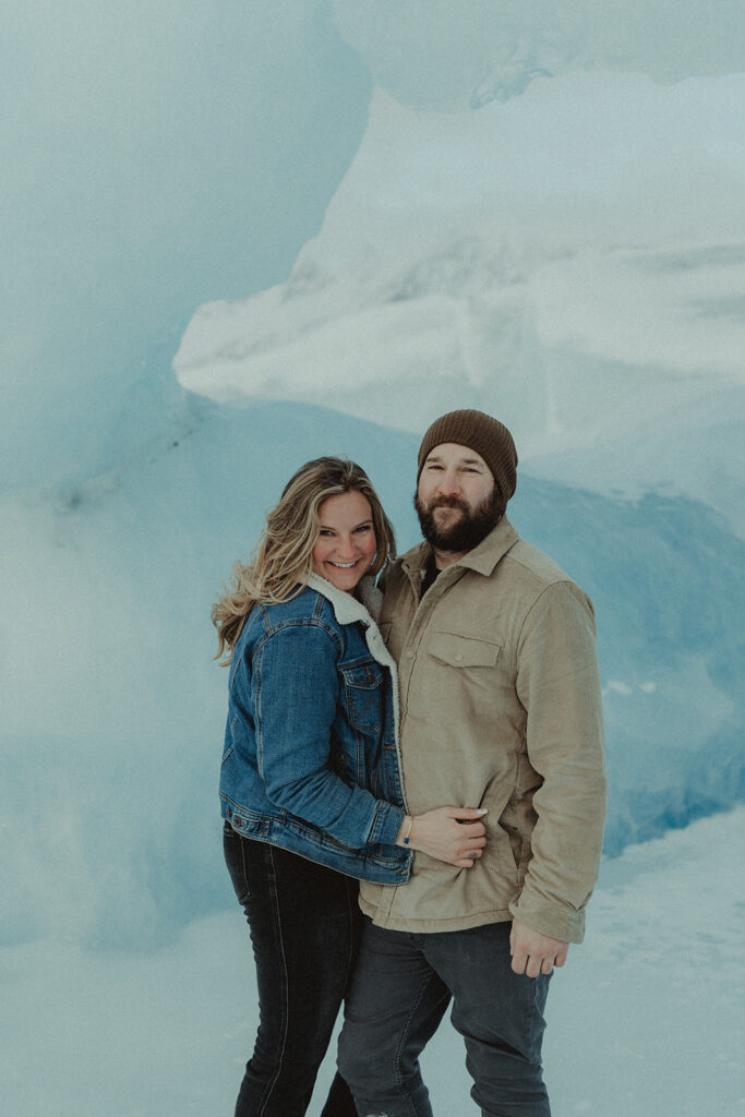 beautiful couple looking at the camera during their engagement photoshoot 