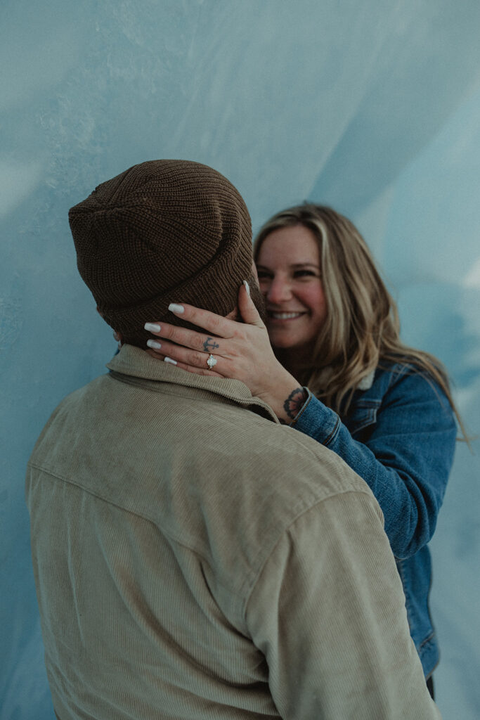 newly engaged couple looking at each other 