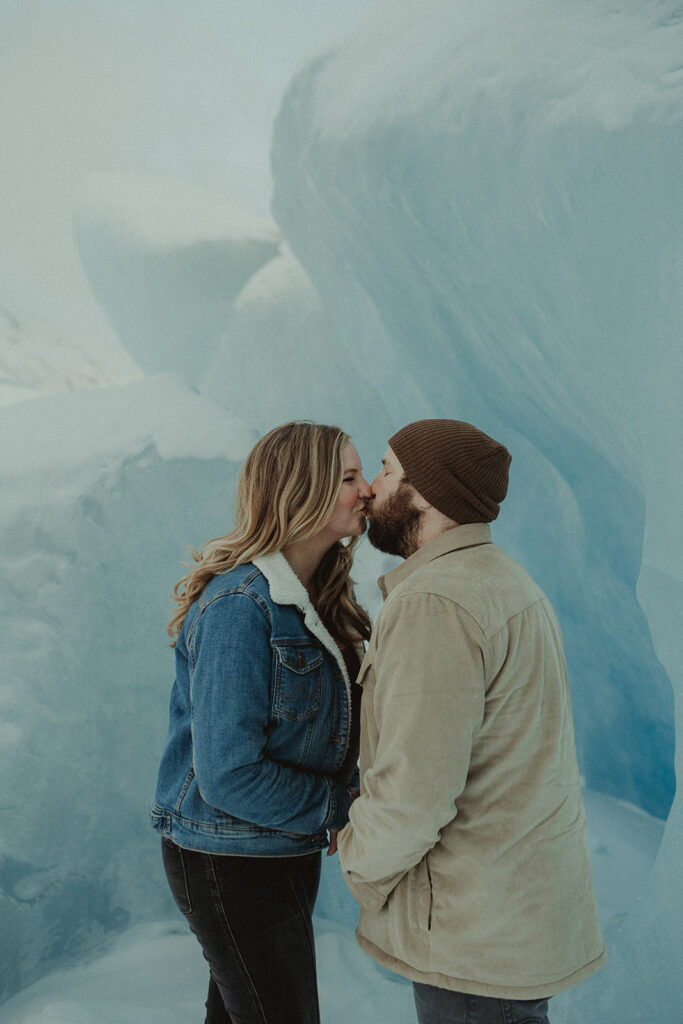 couple kissing during their winter engagement photoshoot