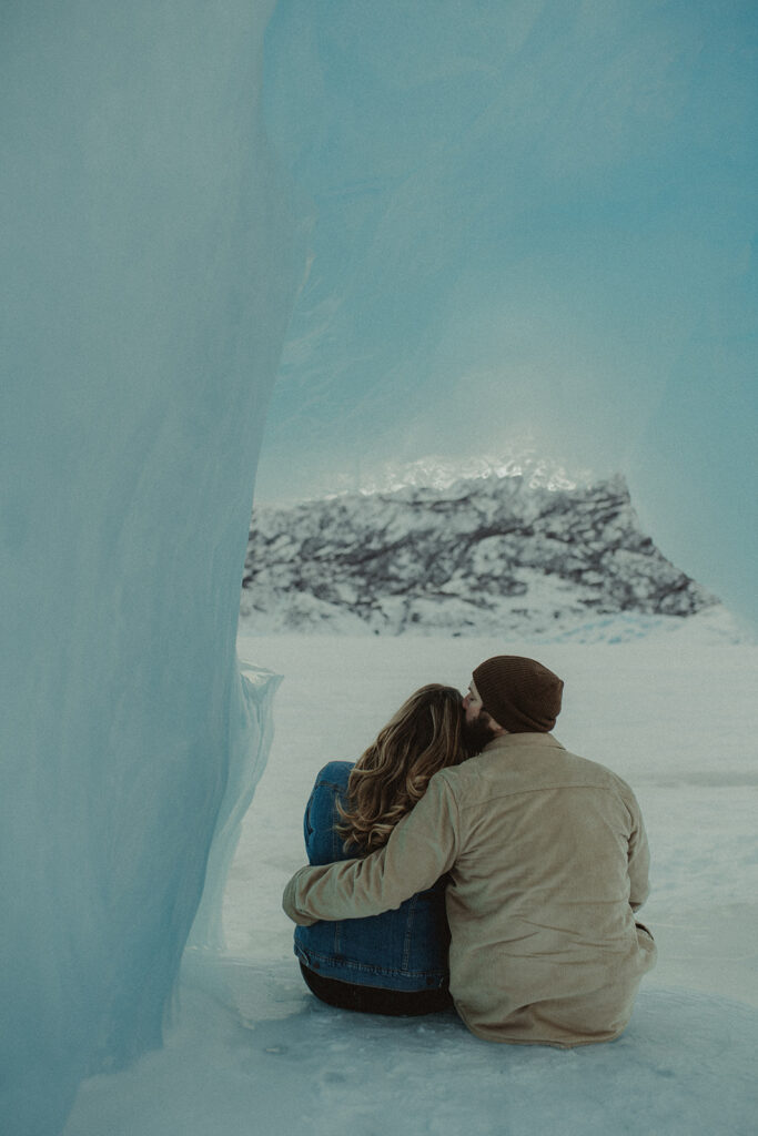 couple hugging looking at the amazing glacier 