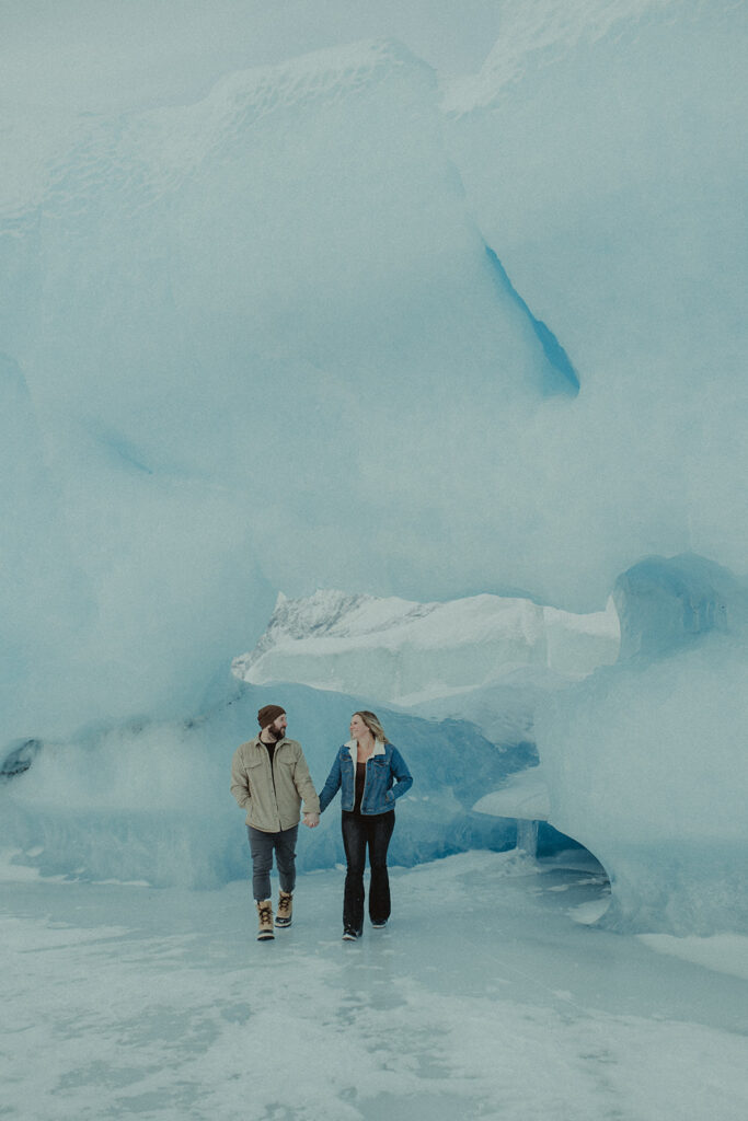 couple holding hands walking around knik glacier 