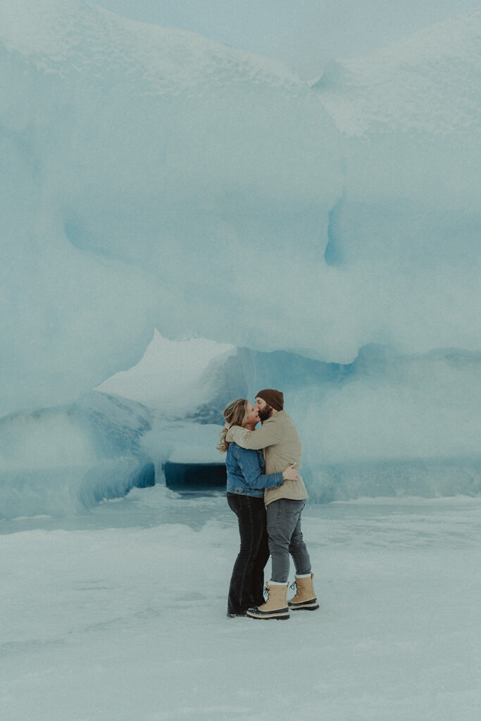 newly engaged couple kissing at their winter engagement 