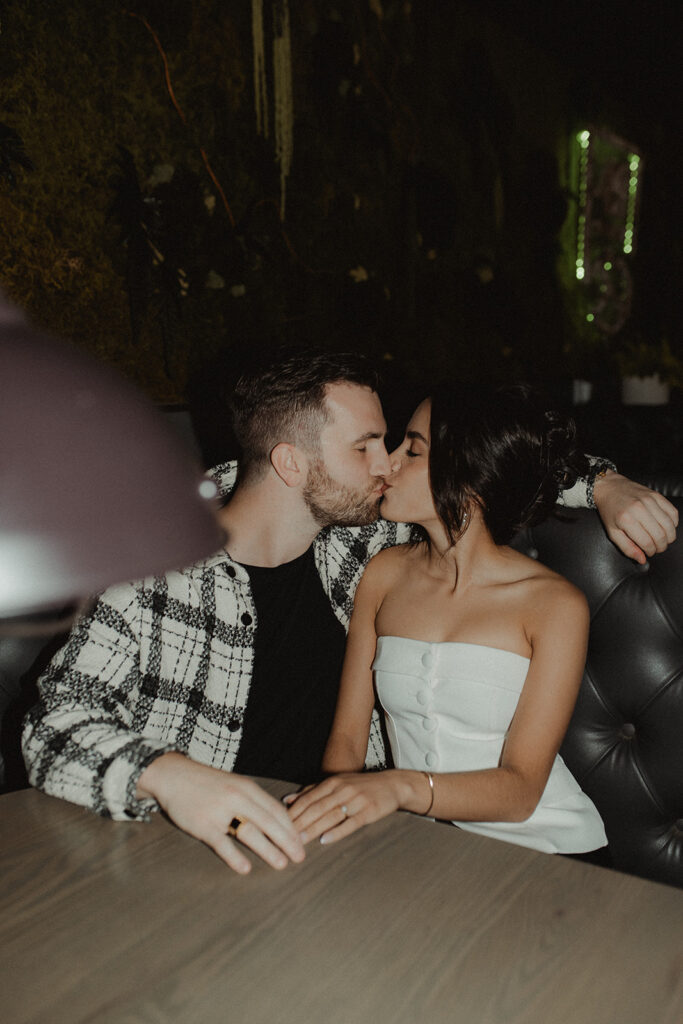 newly engaged couple kissing