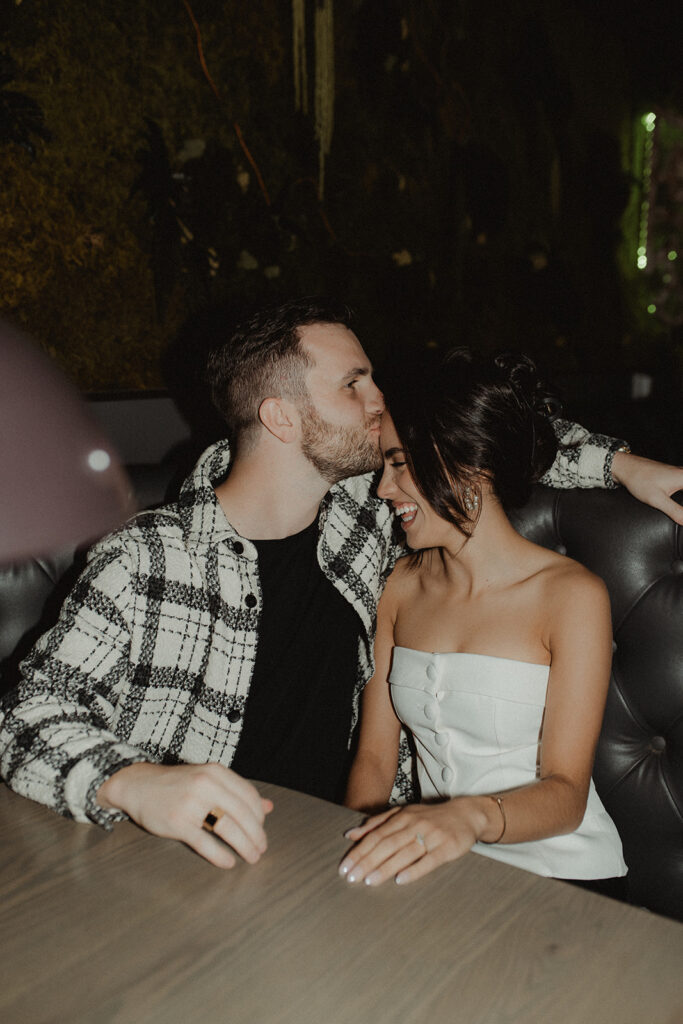 fiance kissing his fiance on the forehead